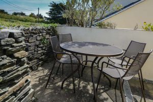 Outside seating area on patio with field views at Aquataine Annexe