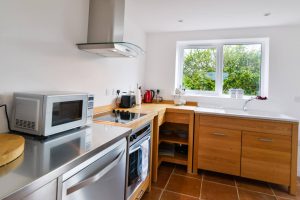 Fully equipped kitchen with window over sink at Aquataine Annexe