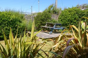 Grassed garden area with bench at Aquataine Lodge
