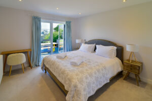Ground floor Superking ensuite bedroom at Blue Seas with double patio doors