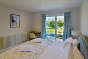 Superking ensuite bedroom on ground floor with double patio doors