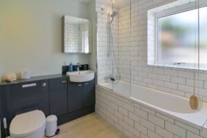 Ensuite from Bedroom 2 at Blue Seas with bath and overhead shower