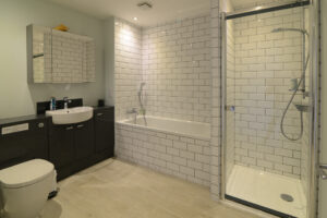 Spacious ensuite bathroom from Bedroom 2 with separate bath and shower