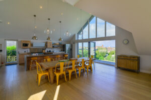 Open plan kitchen and dining area at Blue Seas with sliding doors to balcony