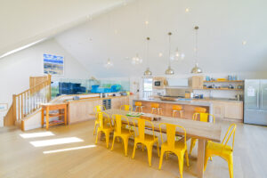 Open plan kitchen and dining area, ample seating with steps to mezzanine lounge at Blue Seas
