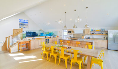 Open plan kitchen and dining area, ample seating with steps to mezzanine lounge at Blue Seas