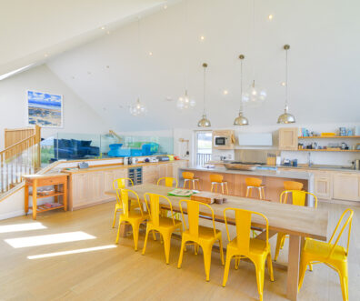 Open plan kitchen and dining area, ample seating with steps to mezzanine lounge at Blue Seas