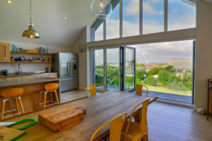 Doors open onto balcony from kitchen and dining area at Blue Seas