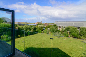 View of grassed garden area from first floor balcony at Blue Seas