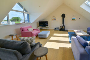 Lounge at Blue Seas with TV and log burner