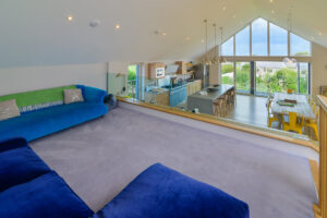 View from mezzanine lounge onto open plan kitchen and dining area at Blue Seas