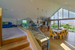 View into open plan kitchen area from stairs at Blue Seas