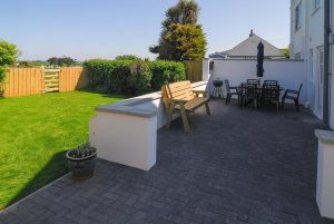 Rear patio with seating and BBQ at Carnavis Cottage