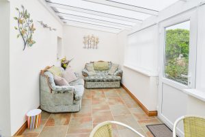 Conservatory at Carnavis Cottage with door leading to front garden