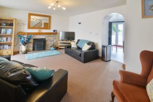 Seating in lounge at Carnavis Cottage with TV and gas fired log burner