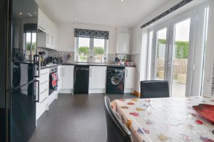 Well equipped kitchen at Carnavis Cottage with double doors to garden