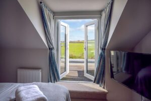 Double doors onto balcony from twin room at Penjerrick