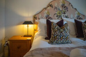 Bed and bedside table in king bedroom at Penjerrick