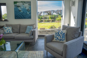Sitting room at Morvoren with seating and large windows