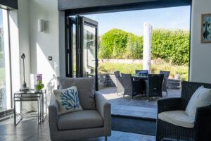 Bi fold doors in the sitting room leading onto patio area at Morvoren