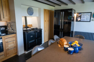 Large double fridge, freezer in the kitchen at Morvoren with dining table and AGA