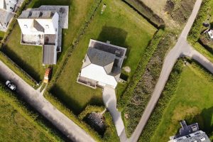 Aerial view of south Corner and wrap around grassed lawn