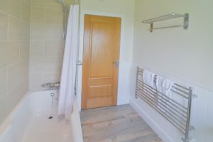 Heated towel rails and overhead shower in main bathroom at Gortheren