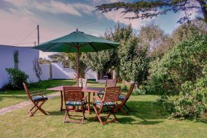 Large rear grassed garden with outdoor seating at Gortheren