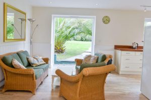 Seating area in kitchen with double doors to the back garden at Gortheren