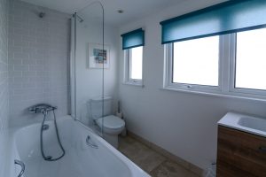 First floor bathroom with bath, shower over and toilet