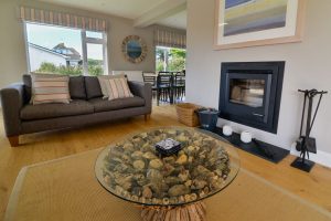 Lounge area at Herongate showing seating, coffee table and woodburner