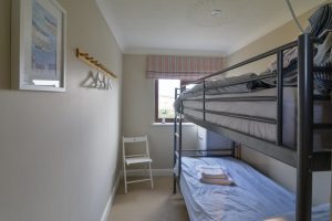 One of the two bunk rooms at High Tides with 1 set of bunk beds