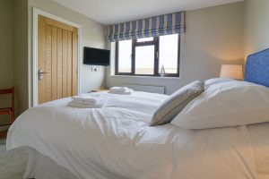 First floor king bedroom with door to ensuite and rural views