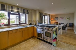 Range oven in kitchen at High Tides leading into dining area