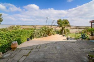 Large patio area in rear garden at High Tides