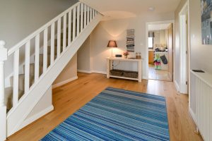 Front entrance hall at High Tides with staircase leading to first floor