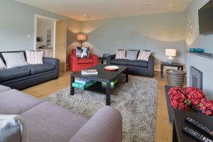 Lounge at High Tides with ample seating and mounted TV