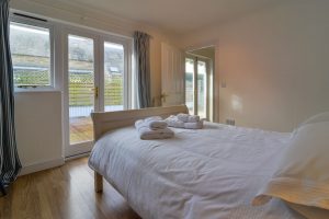 Ground floor ensuite double bedroom with double doors leading to external decking area