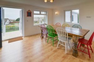 Dining area with double doors leading to decking at Highview