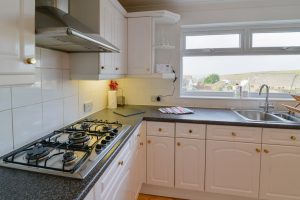 Kitchen at Highview with gas hob and views of the coast from the window