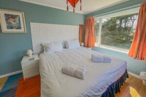 Superking bedroom at Thalassa with large window to garden