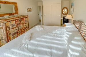 king bedroom at Penamont showing built in wardrobes, chest of drawers and door into hallway
