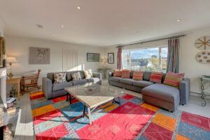 Lounge at Penamont with ample seating and large coffee table with large window to the front of the house