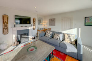 Lounge at Penamont with seating, large coffee table and fireplace with TV over the mantel