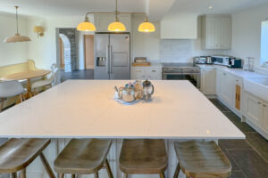 Fully equipped kitchen with large island and bar stools at Aquataine Lodge