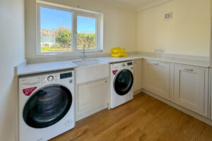 Utility room with washing machine and tumble drier at Aquataine Lodge