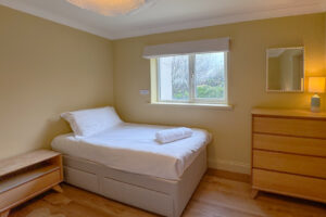 First floor twin bedroom with window at Aquataine Lodge
