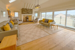 Lounge with log burner and ample seating at Aquataine Lodge