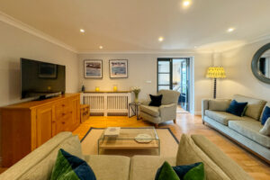 Lounge area at Penjerrick with ample seating and doors to garden room
