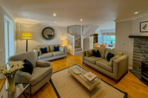 Lounge area at Penjerrick with seating and showing stairs to the first floor